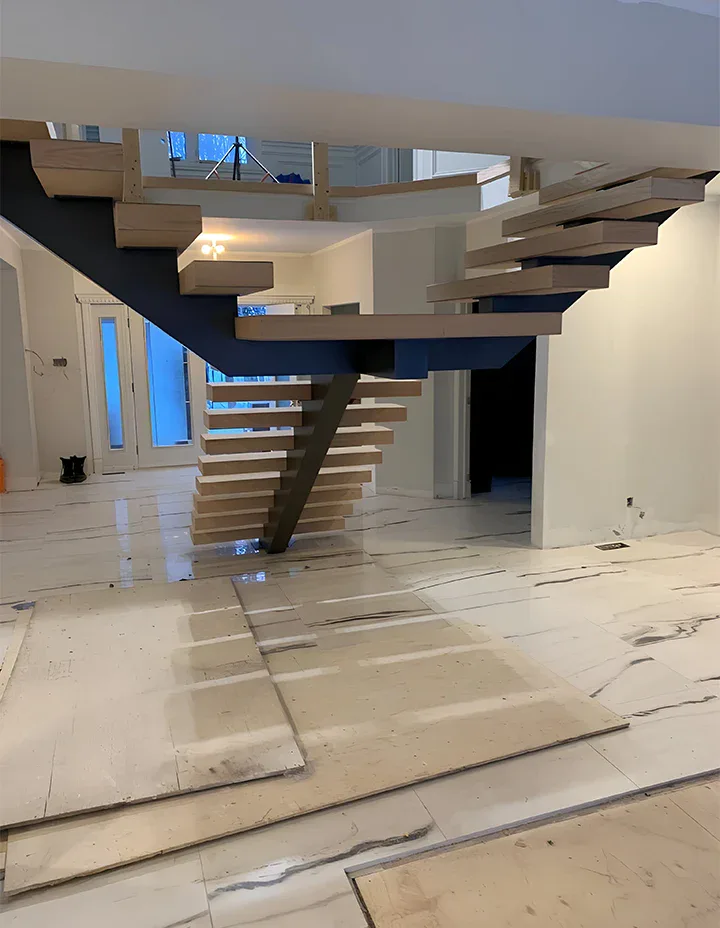 Alt: Custom wood floating staircase with sleek design in modern home interior.