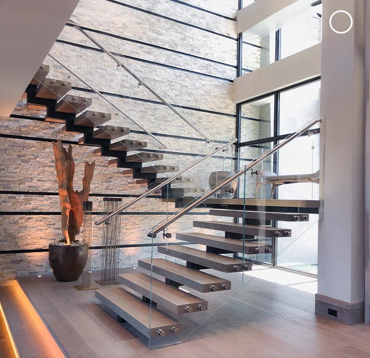 Stunning glass staircase with steel supports and sleek glass panels in a contemporary interior.