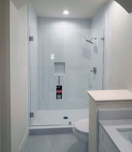 Beautiful clear glass shower door with polished hardware for modern bathroom style.
