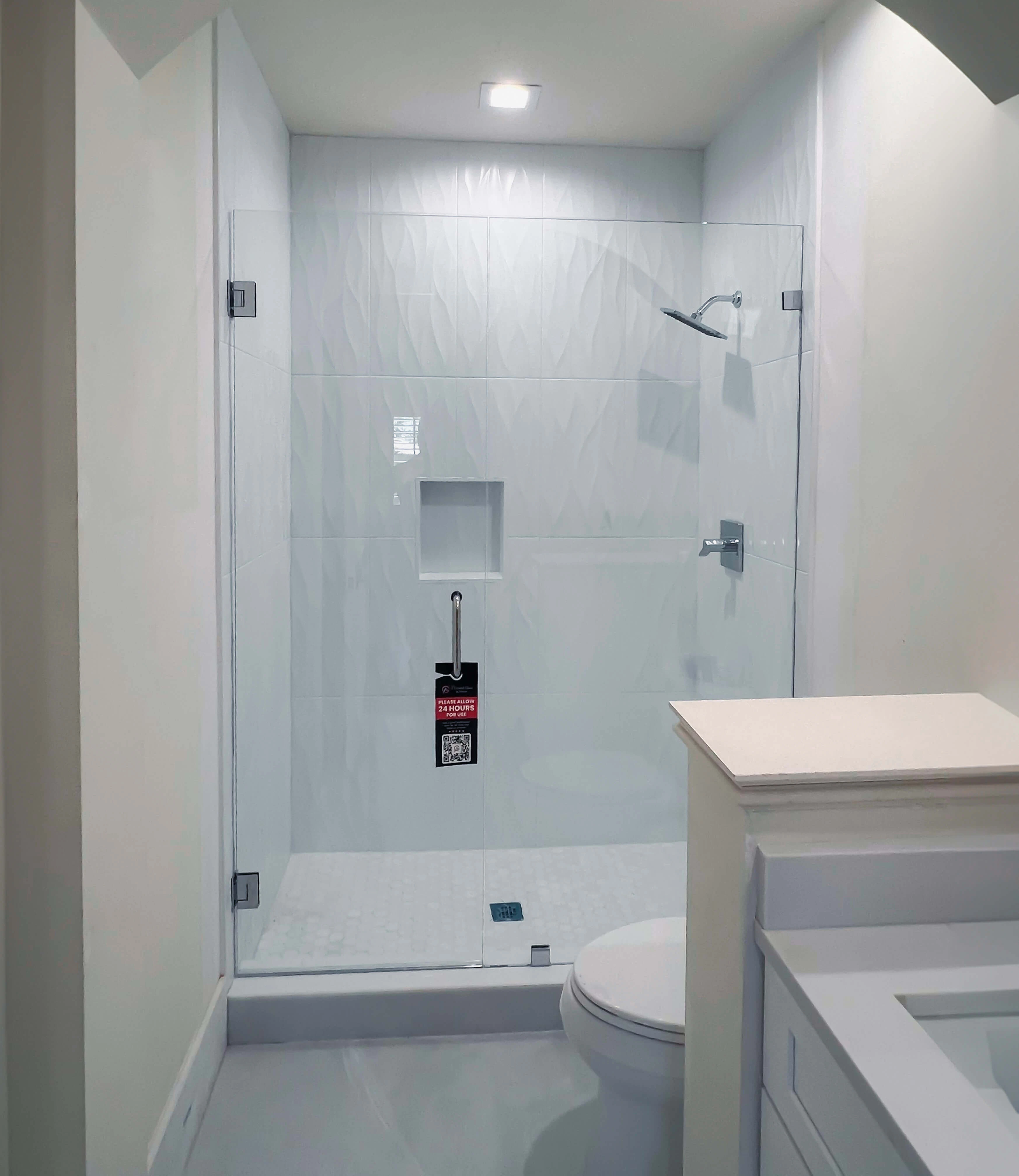 Beautiful clear glass shower door with polished hardware for modern bathroom style.