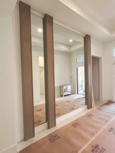 High-quality glass mirror installation in modern interior design.