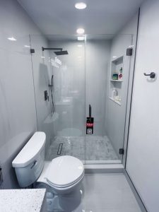 High-quality clear glass shower door with black hardware and built-in niche.