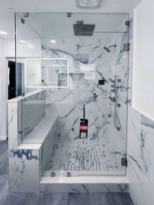 High-quality glass and marble bathroom shower with modern fixtures.