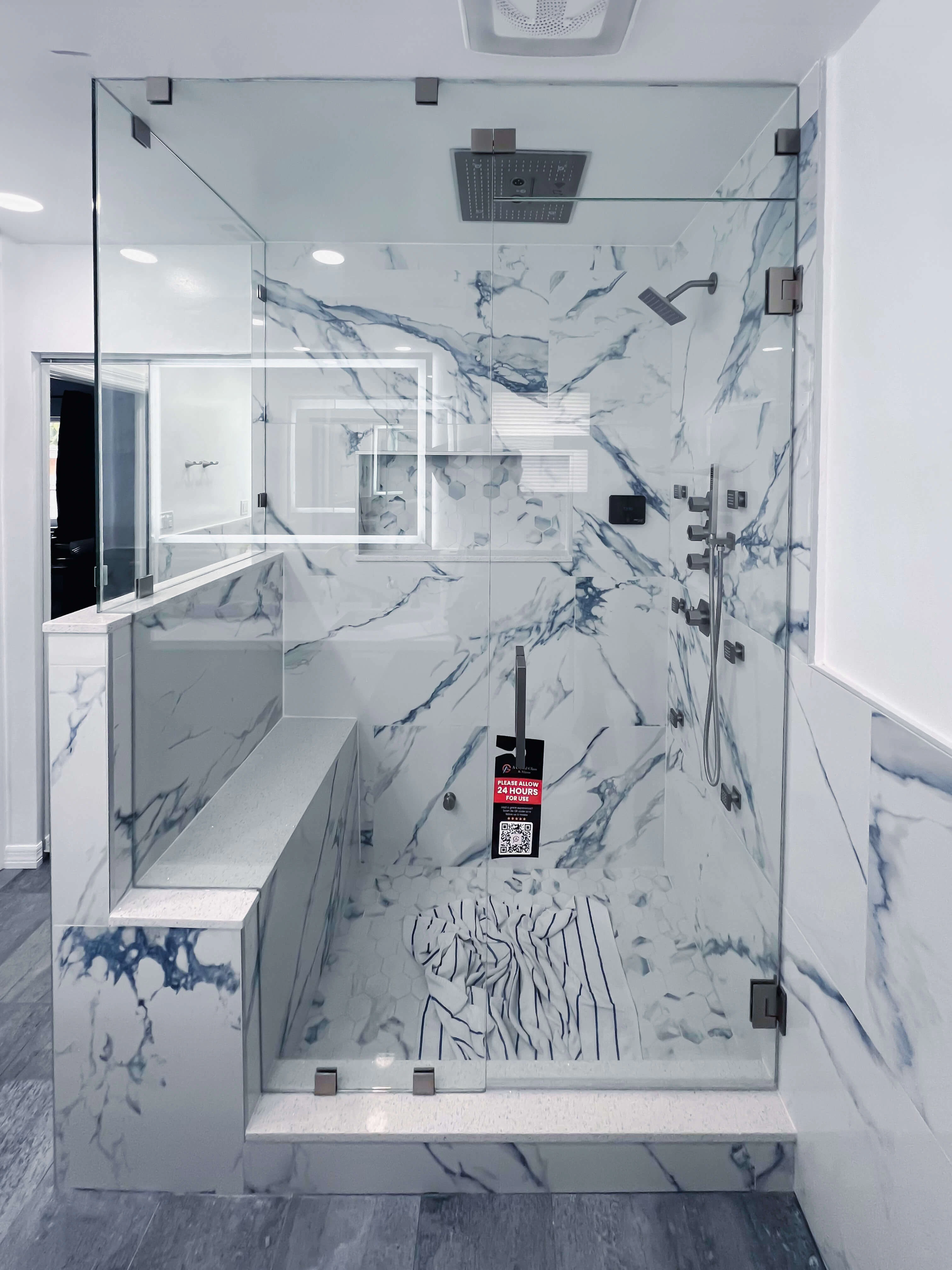 High-quality glass and marble bathroom shower with modern fixtures.