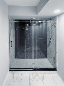 Clear glass shower enclosure with sleek metal hardware. Modern design enhances bathroom elegance.