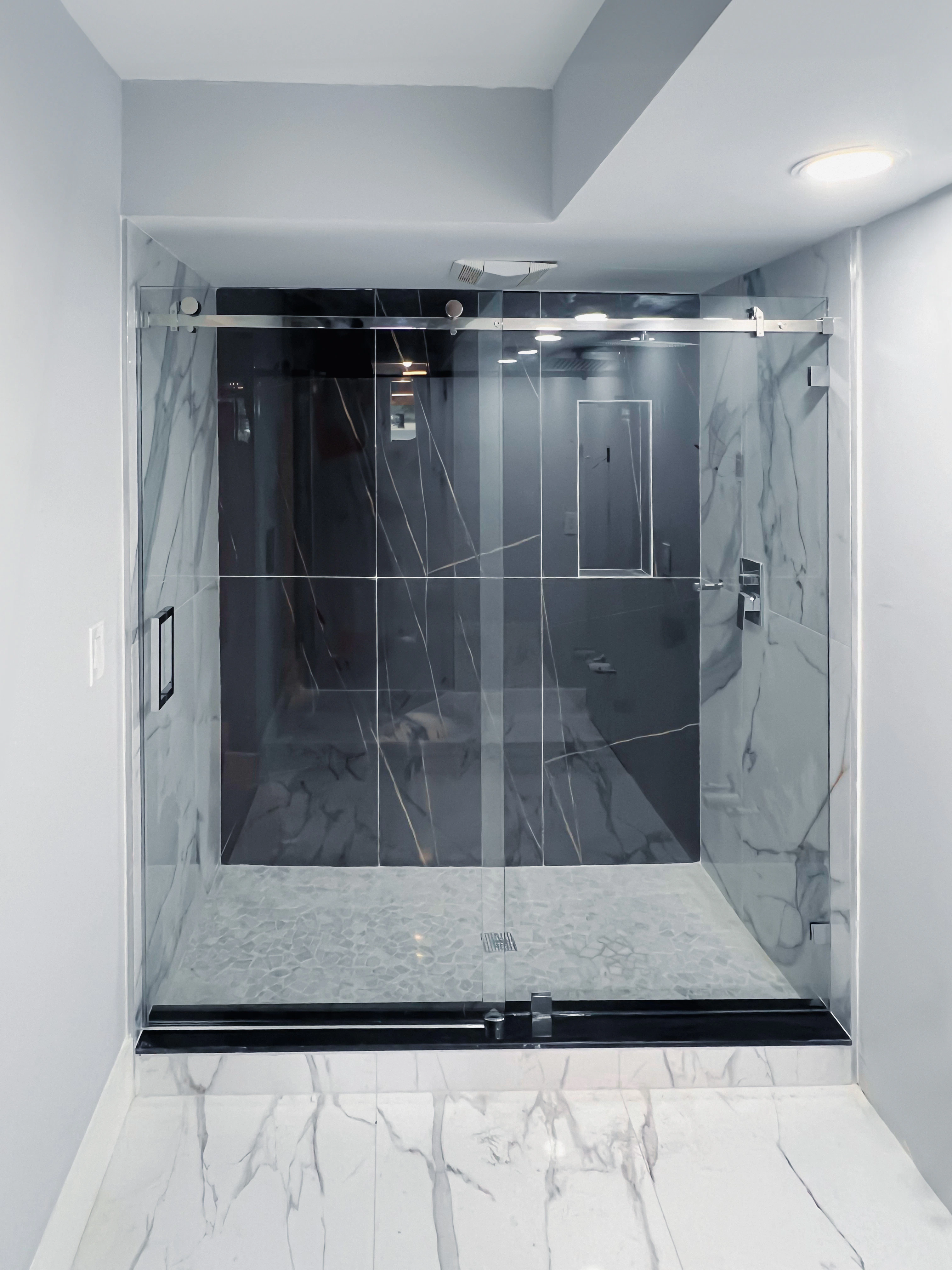 Clear glass shower enclosure with sleek metal hardware. Modern design enhances bathroom elegance.