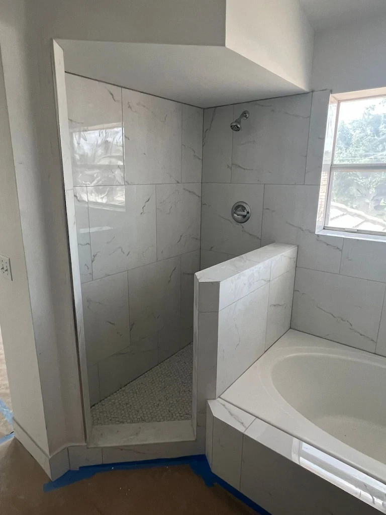 Clear glass shower door for modern bathroom construction.