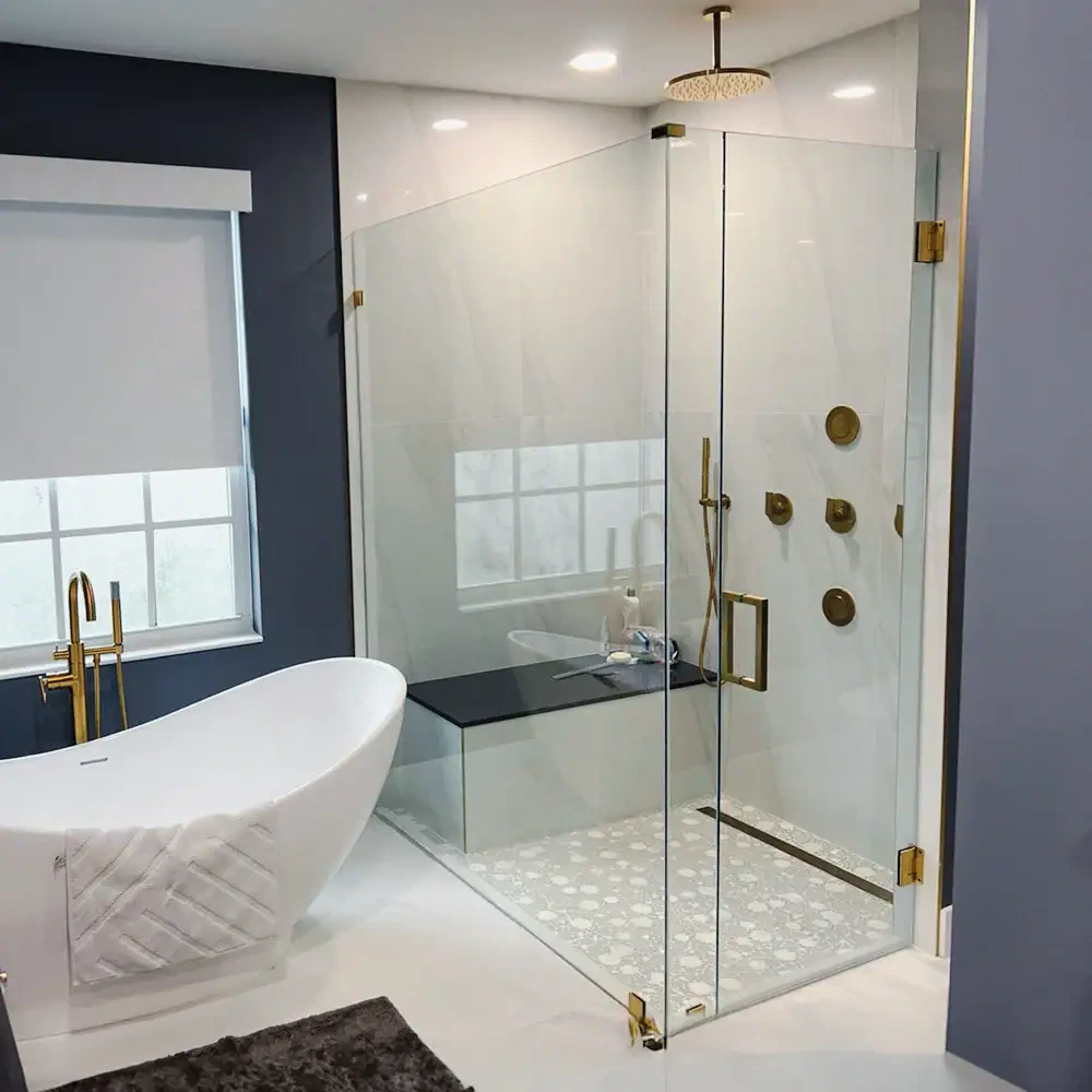 Luxury glass shower with brass hardware in contemporary bathroom setting.