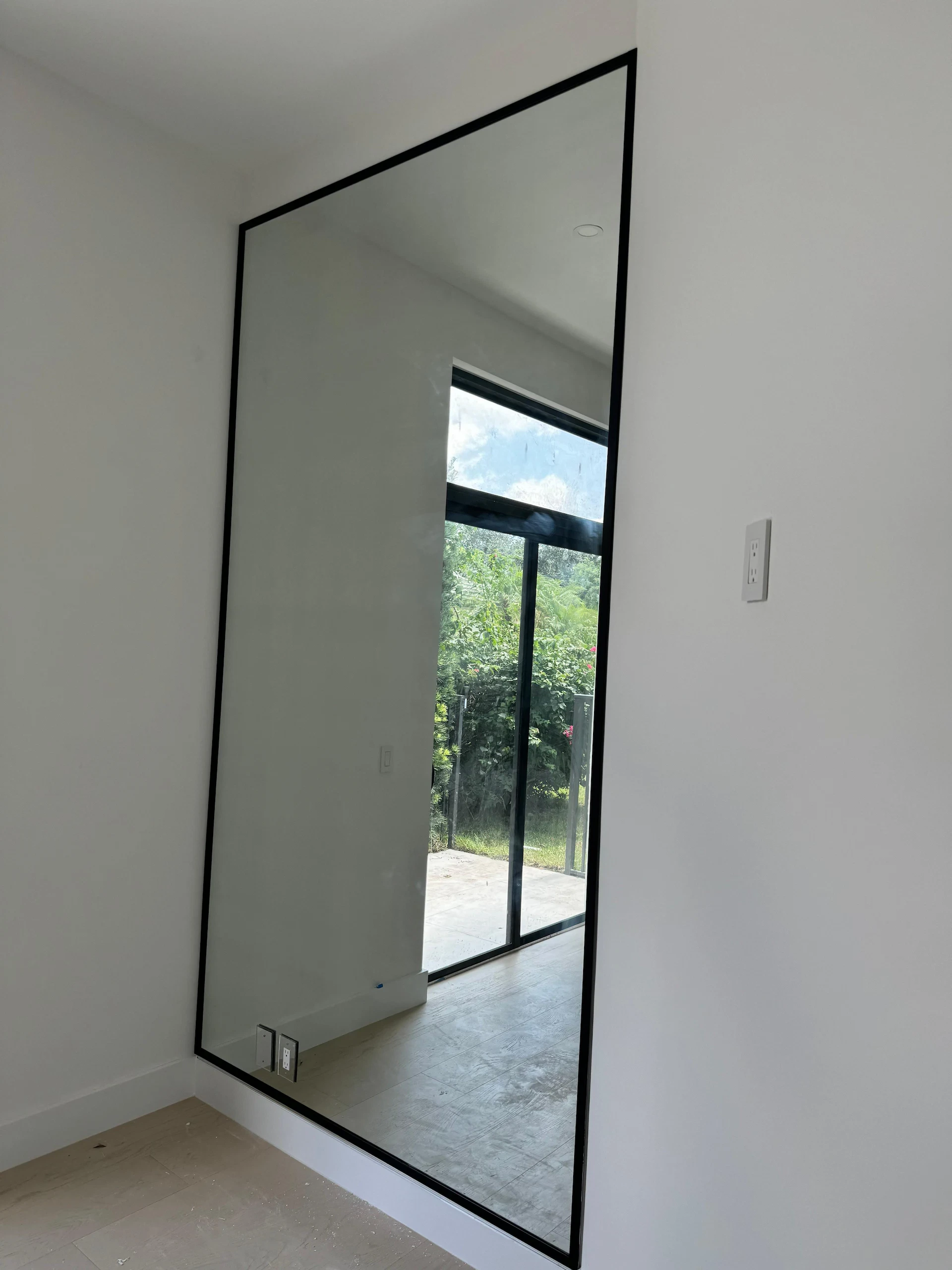 Elegant black framed mirror enhances interior design.