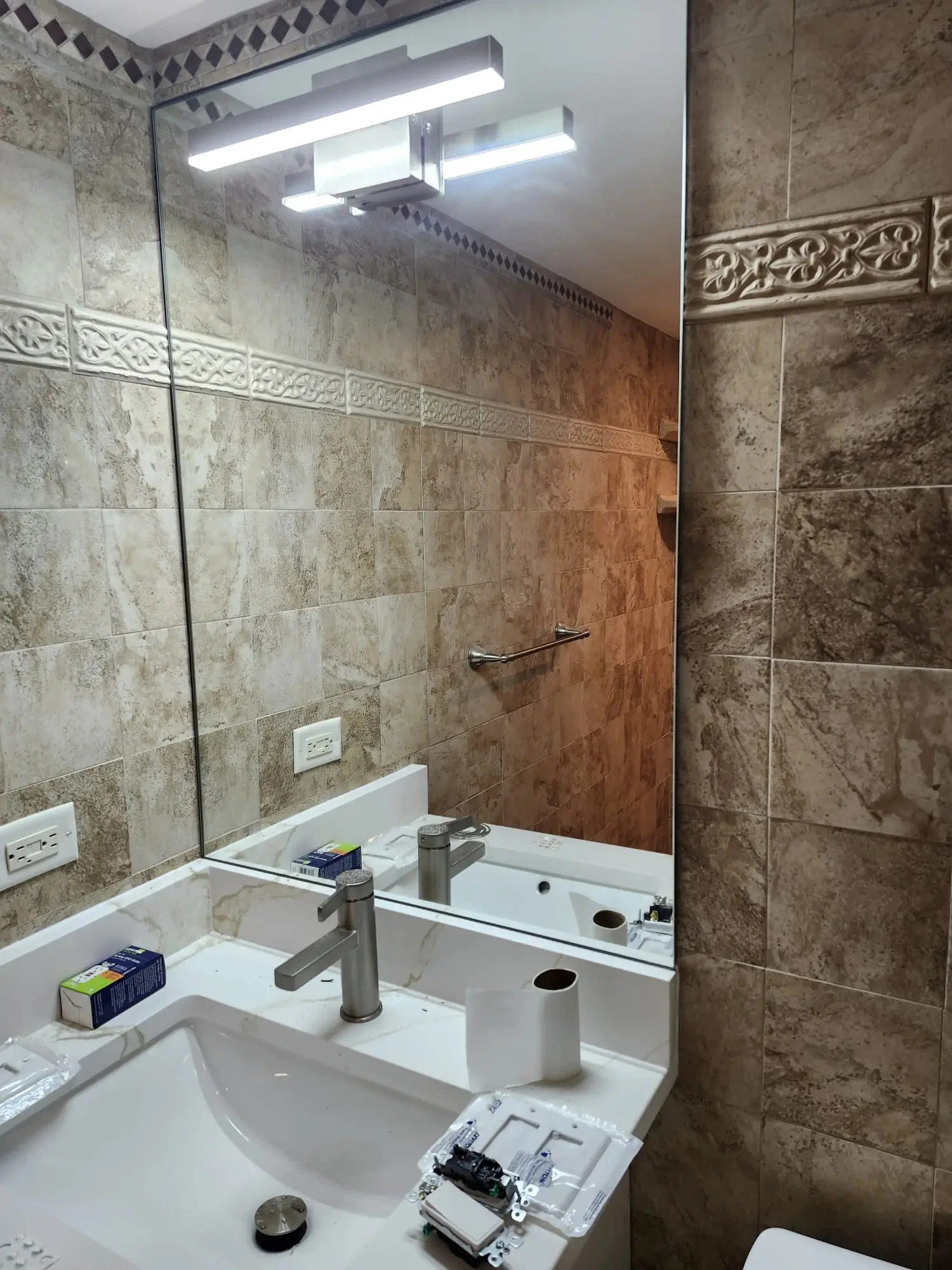 High-quality mirror for bathrooms with elegant tile backdrop. Custom mirror adds style and functionality.