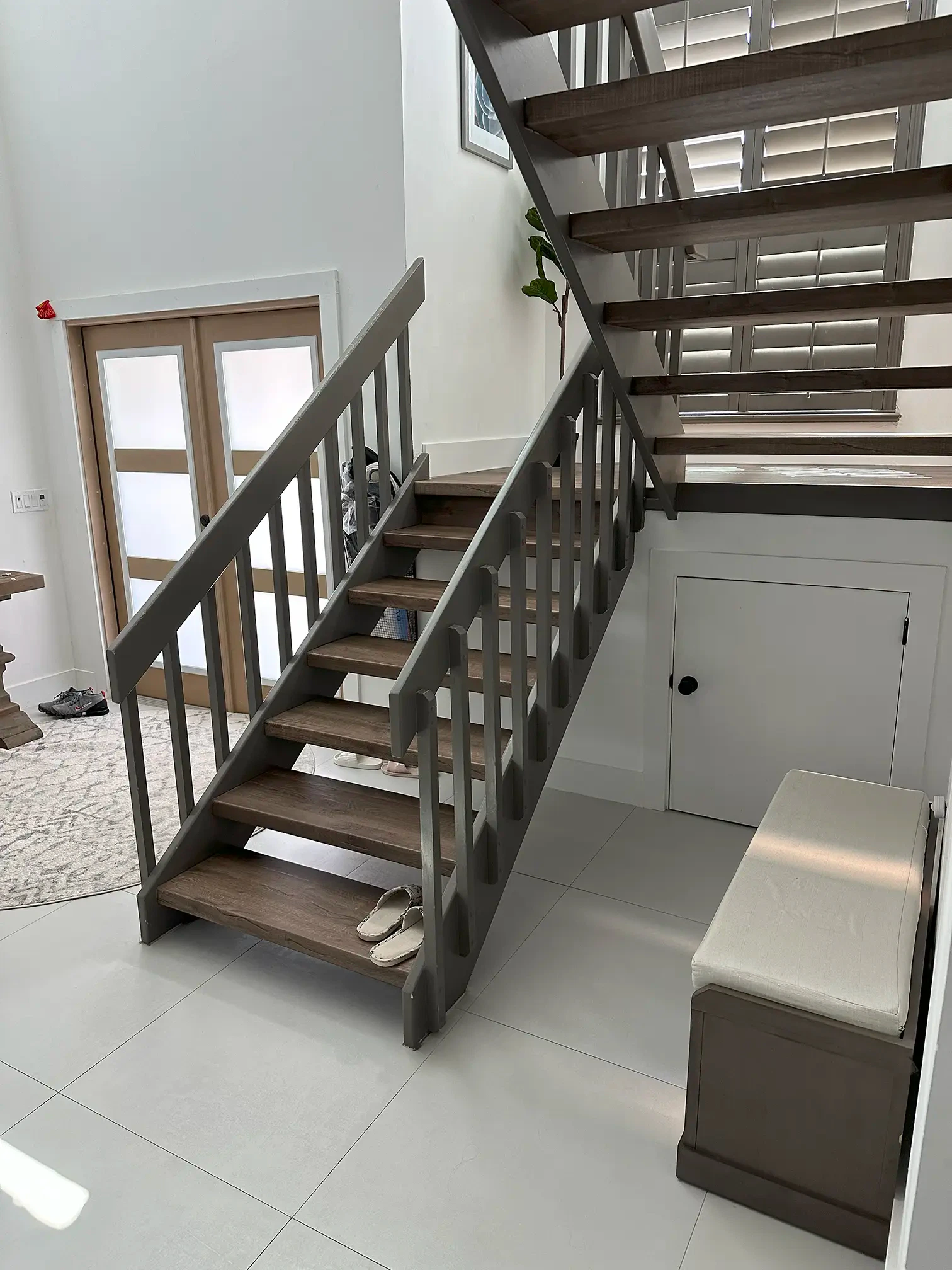 High-quality glass staircase featuring wooden treads and modern metal design.