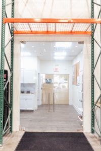 Clear glass entry door with metallic handles, modern design for inviting commercial entrance.