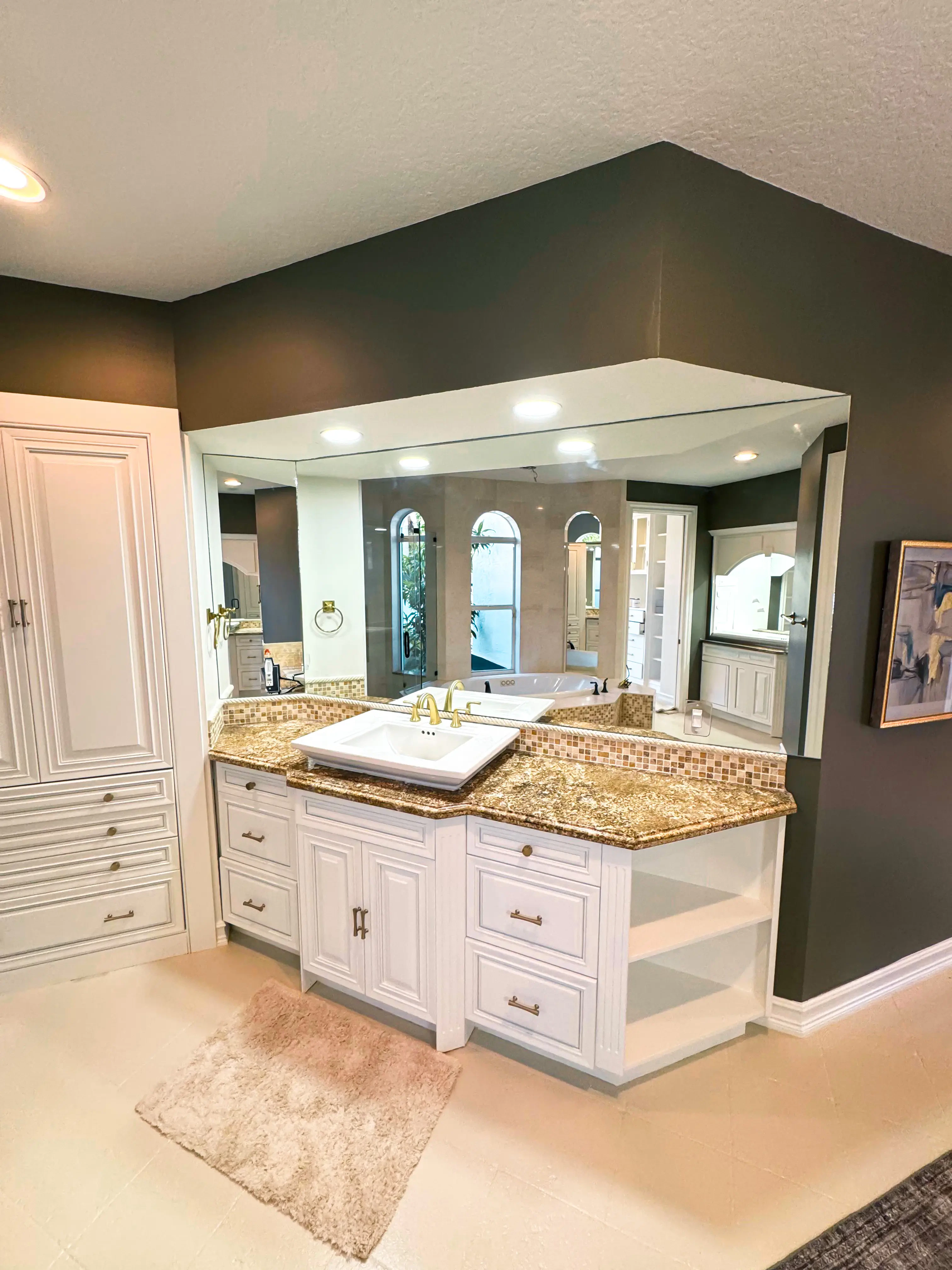 Beautiful bathroom mirror with custom glass, vanity, and elegant fixtures.