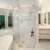 High-end glass shower with gold accents in luxurious bathroom setting.