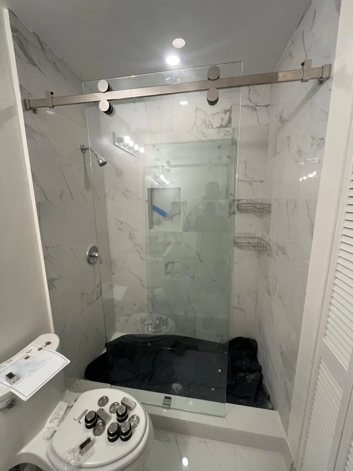 High-quality glass shower door with stainless steel hardware for modern bathrooms.