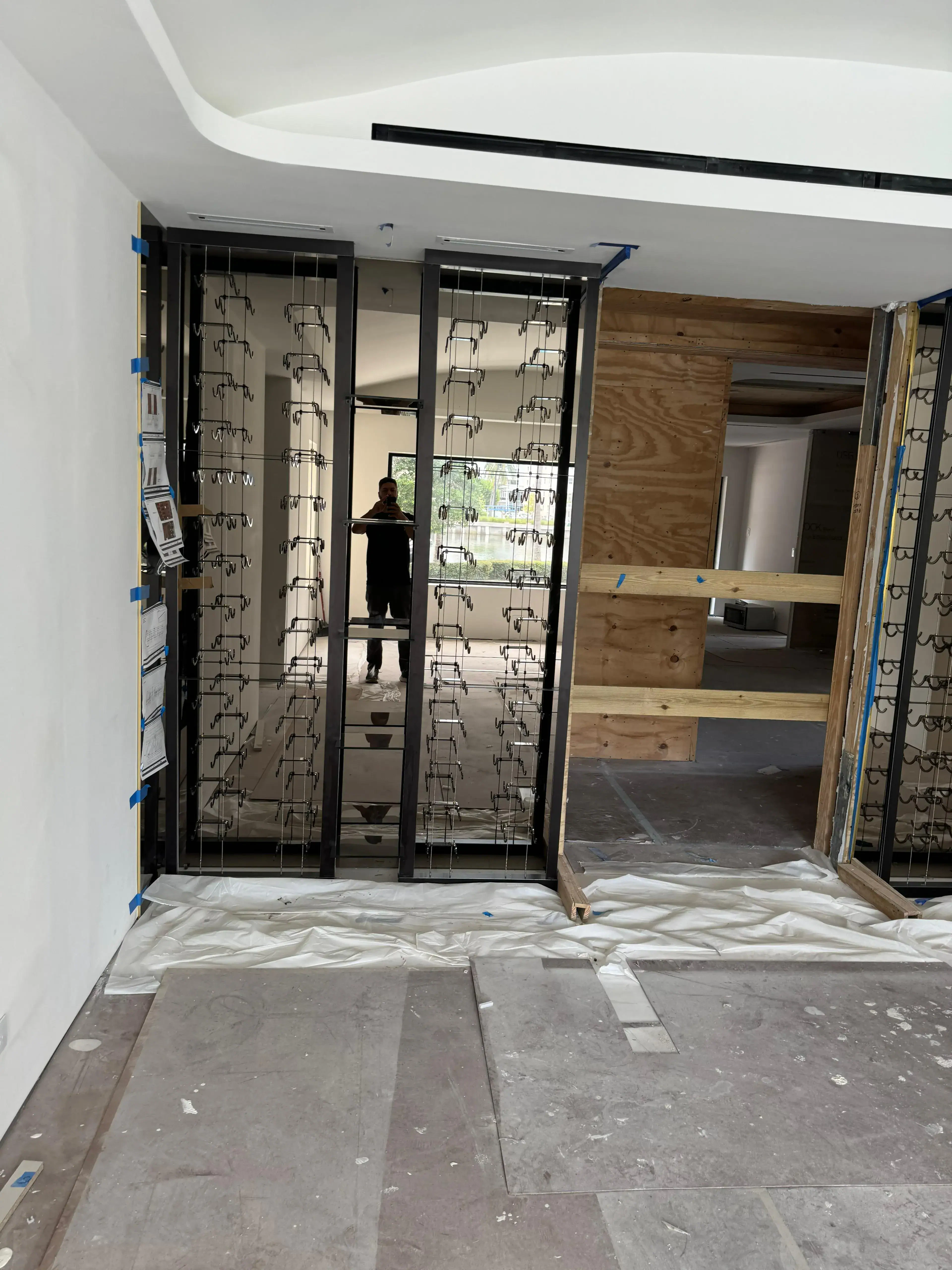 High-quality glass mirror and custom metal framing in progress at a commercial project.