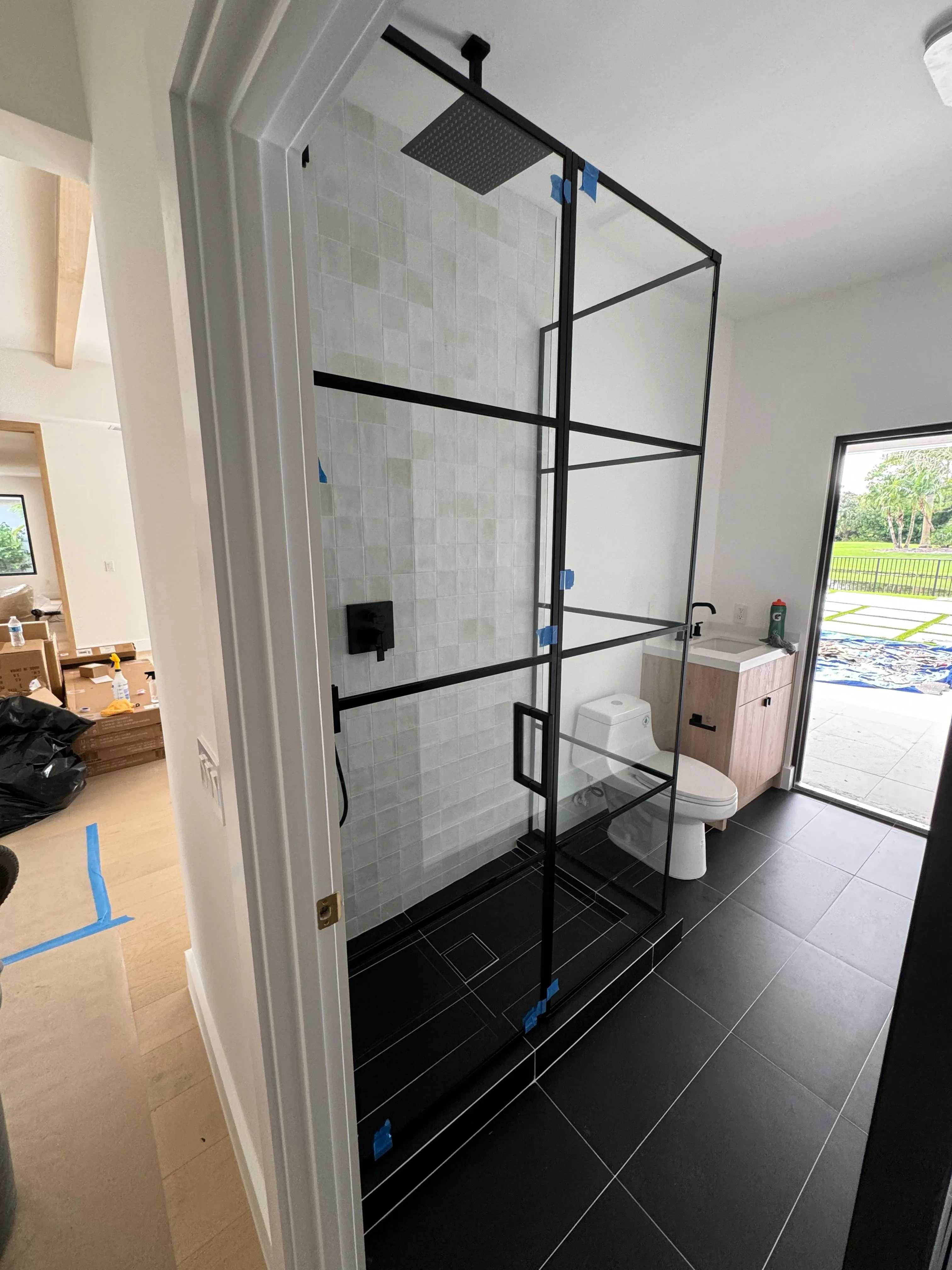 Elegant glass shower with black framing, perfect for contemporary bathroom designs.