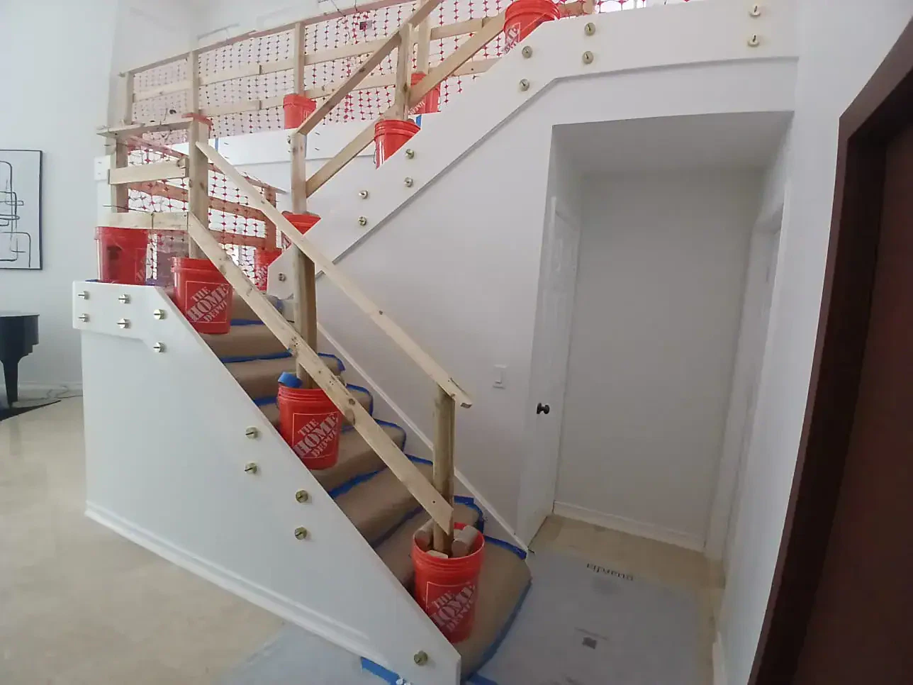 High-quality glass staircase railing with sturdy wooden handrails and decorative hardware, ideal for elegant home interiors.