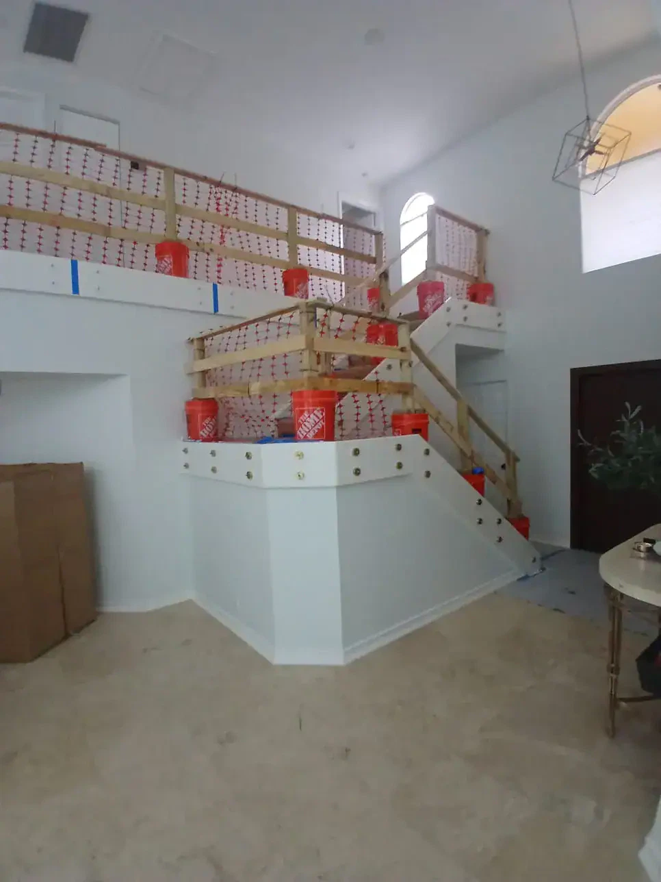 Durable glass railing with wooden handrails installed on staircase for modern home design.