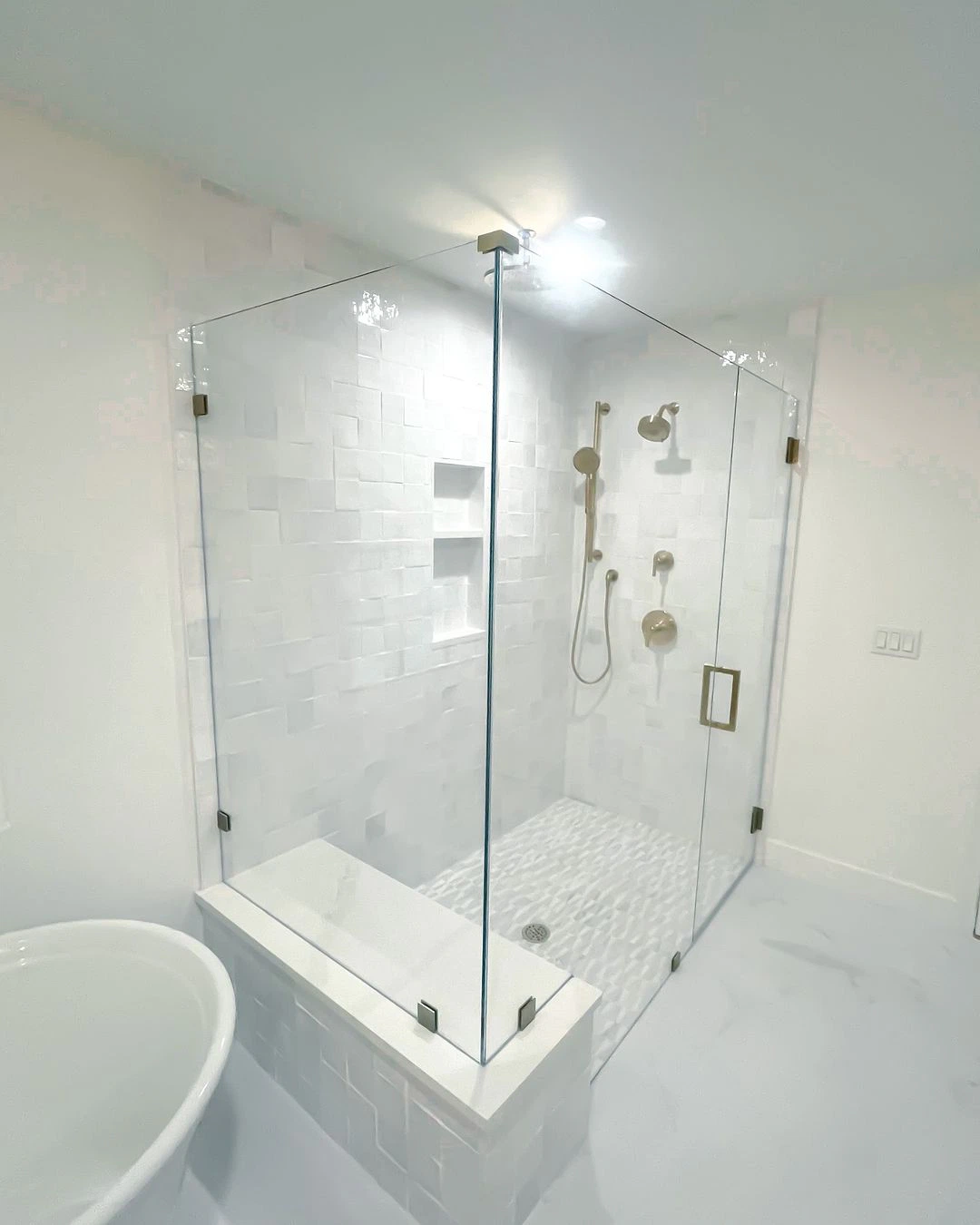 High-quality glass shower door with brass hardware, sleek design, and waterproof tiles. Perfect for modern bathrooms.