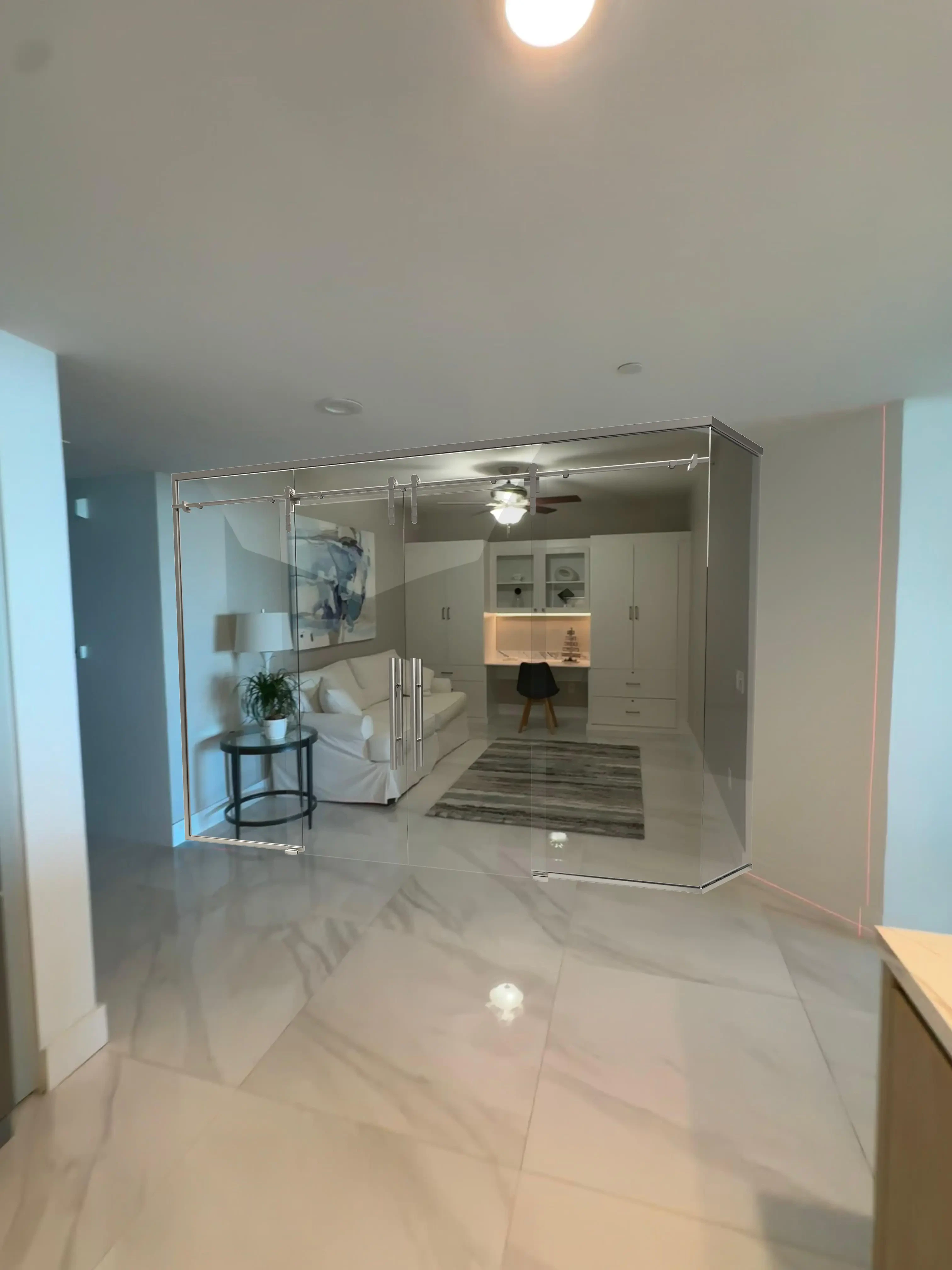 Elegant glass room divider with sliding doors, enhances modern home interior design.