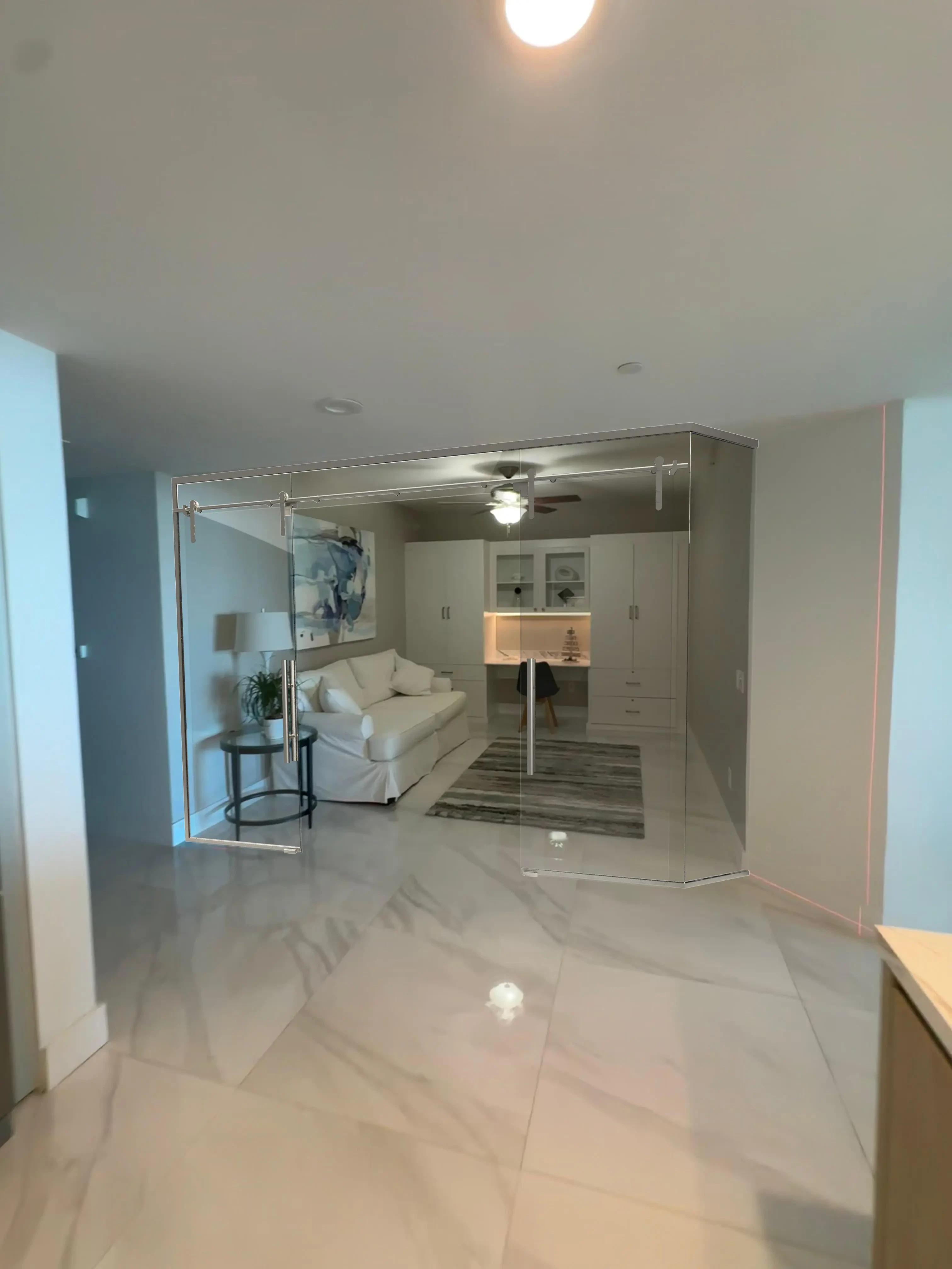 Elegant glass wall partition in modern living room, enhances space and decor.