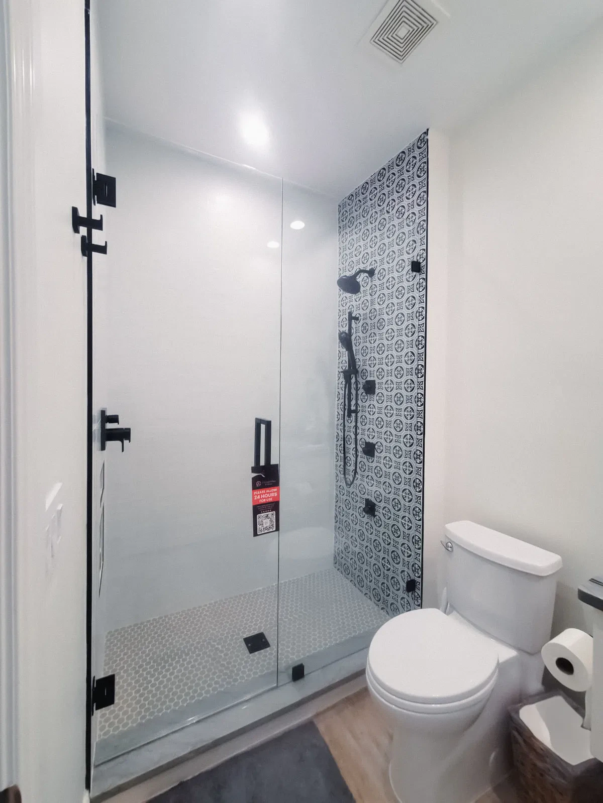 Stylish bathroom with glass shower door and modern fixtures.