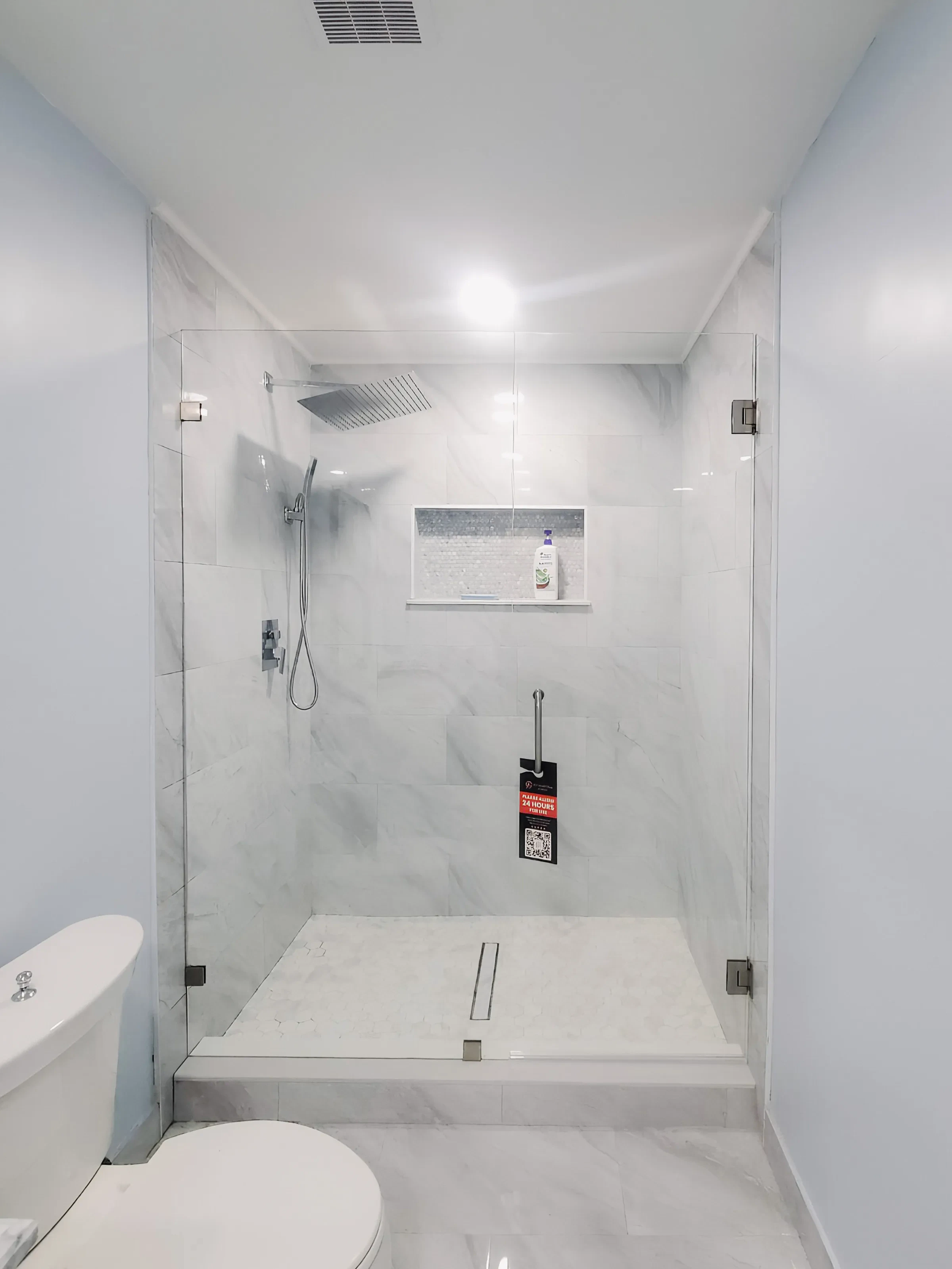 Elegant glass shower door with sleek hardware, perfect for contemporary bathrooms.