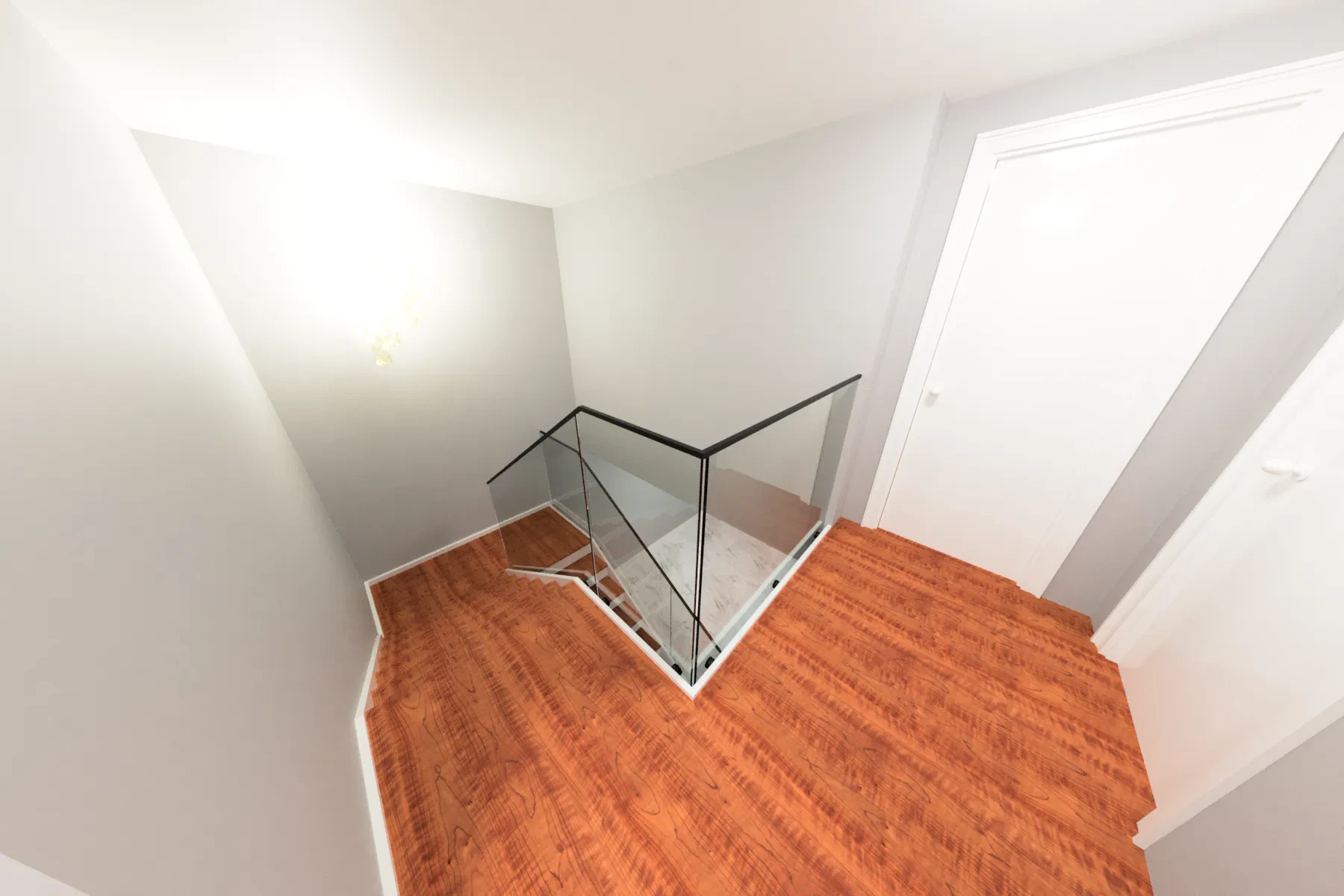 Staircase featuring glass panels and sleek black metal railing in a modern interior.