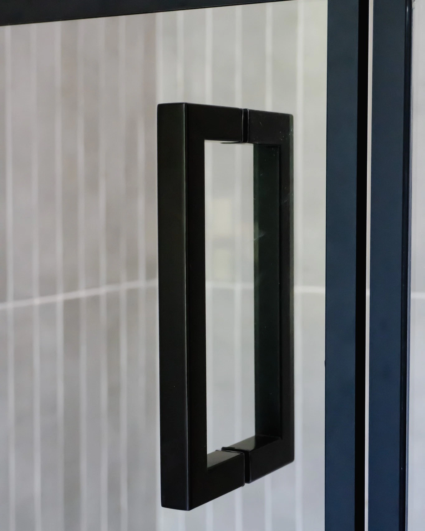 Contemporary black glass door handle for home or office doors.