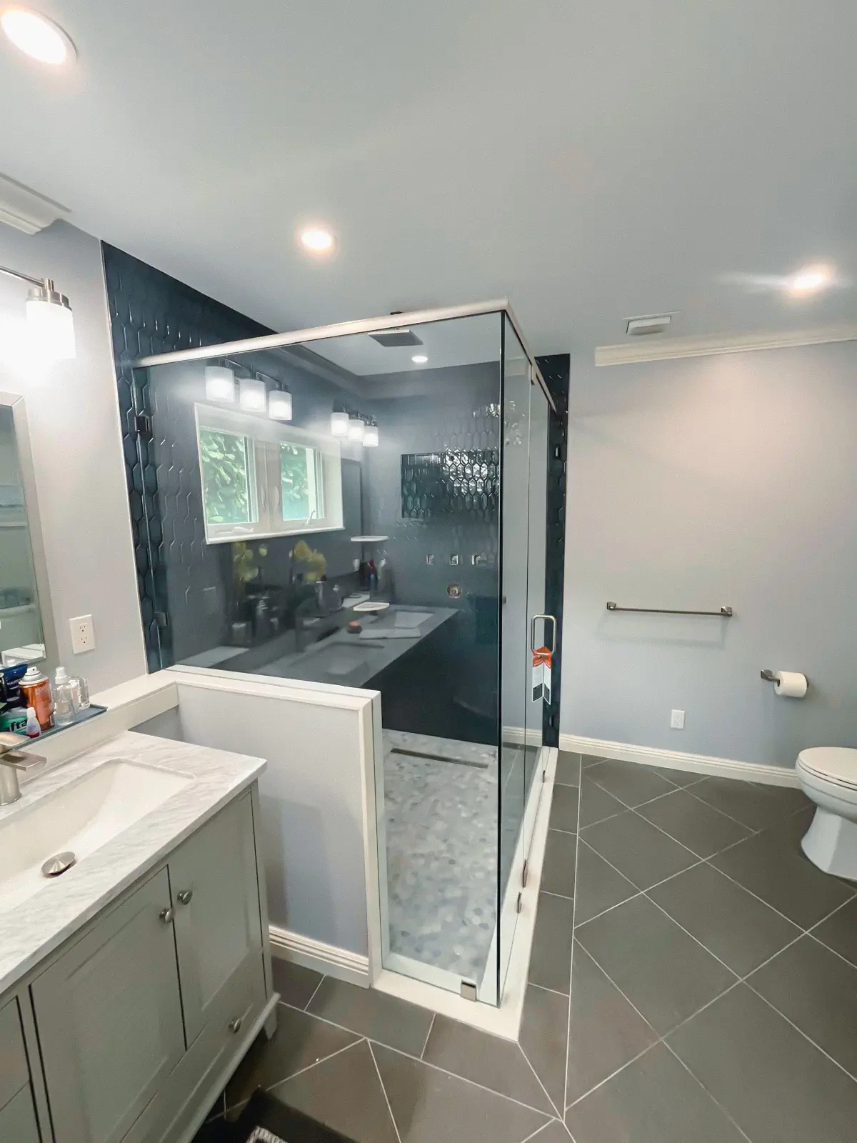 Durable glass shower door with sleek mirror and vanity for stylish bathroom upgrades.