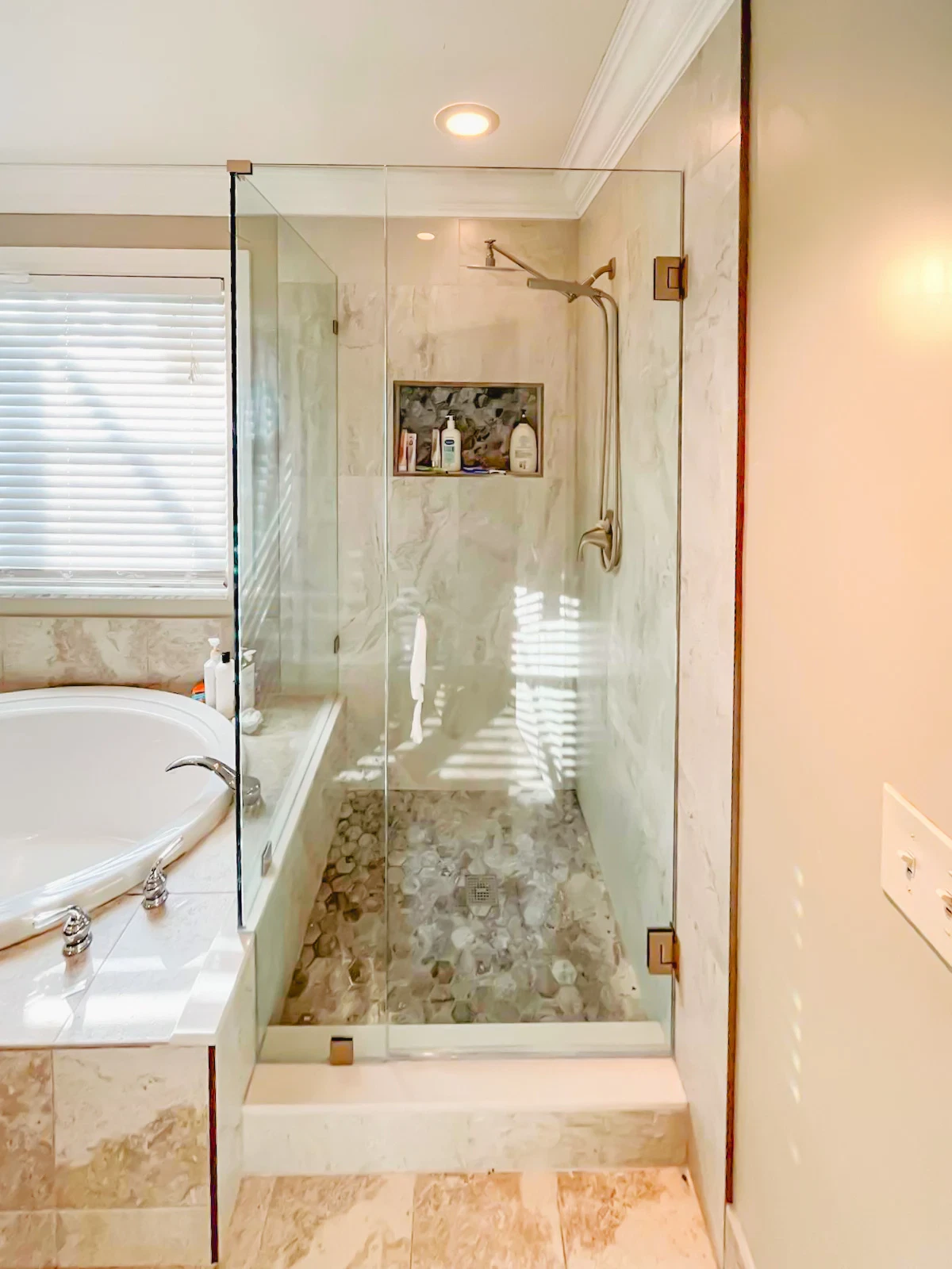High-quality glass shower door with metal hinges and minimalist design.