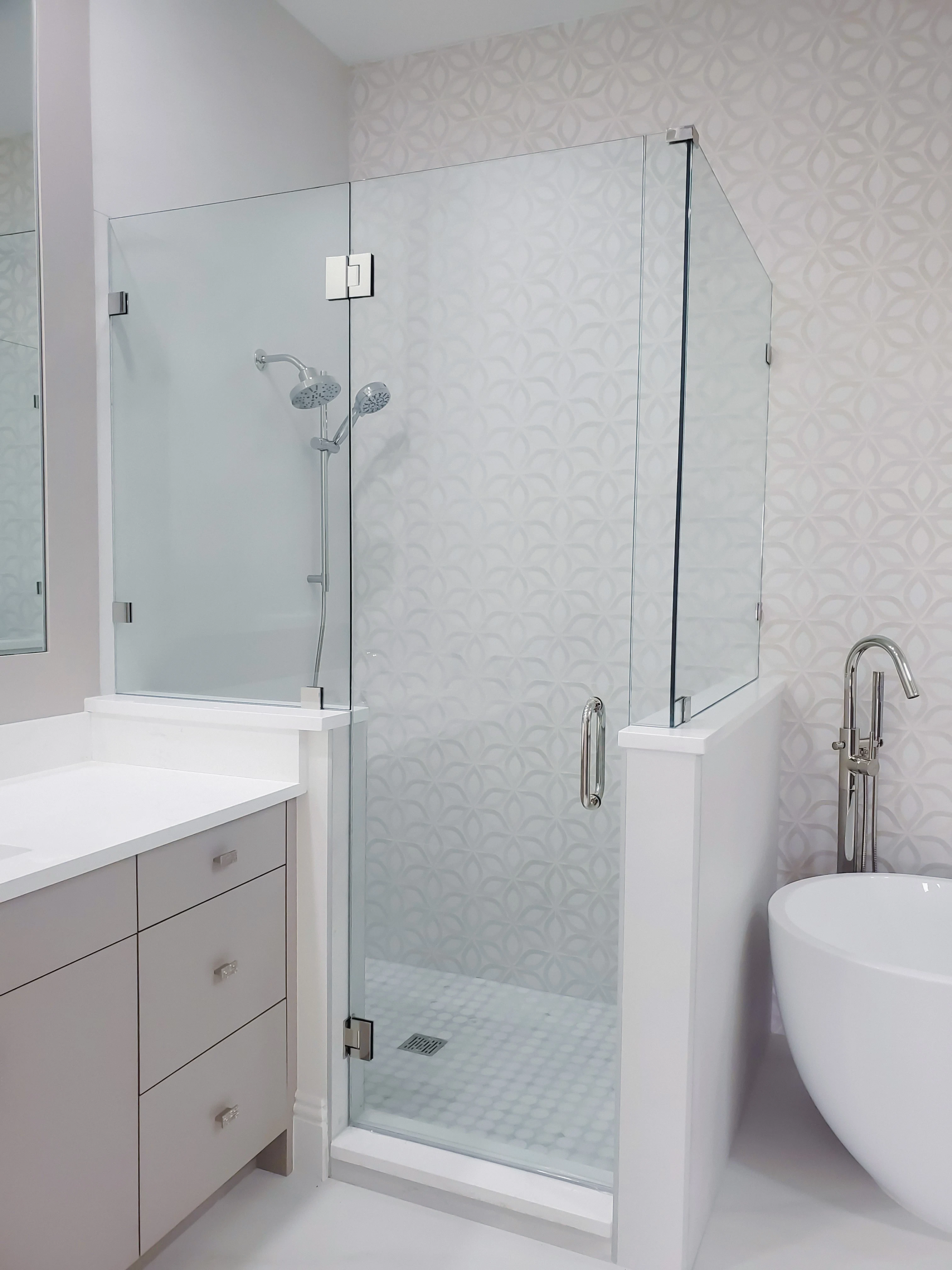 Clear glass shower door with sleek hardware, enhancing bathroom aesthetics and functionality.