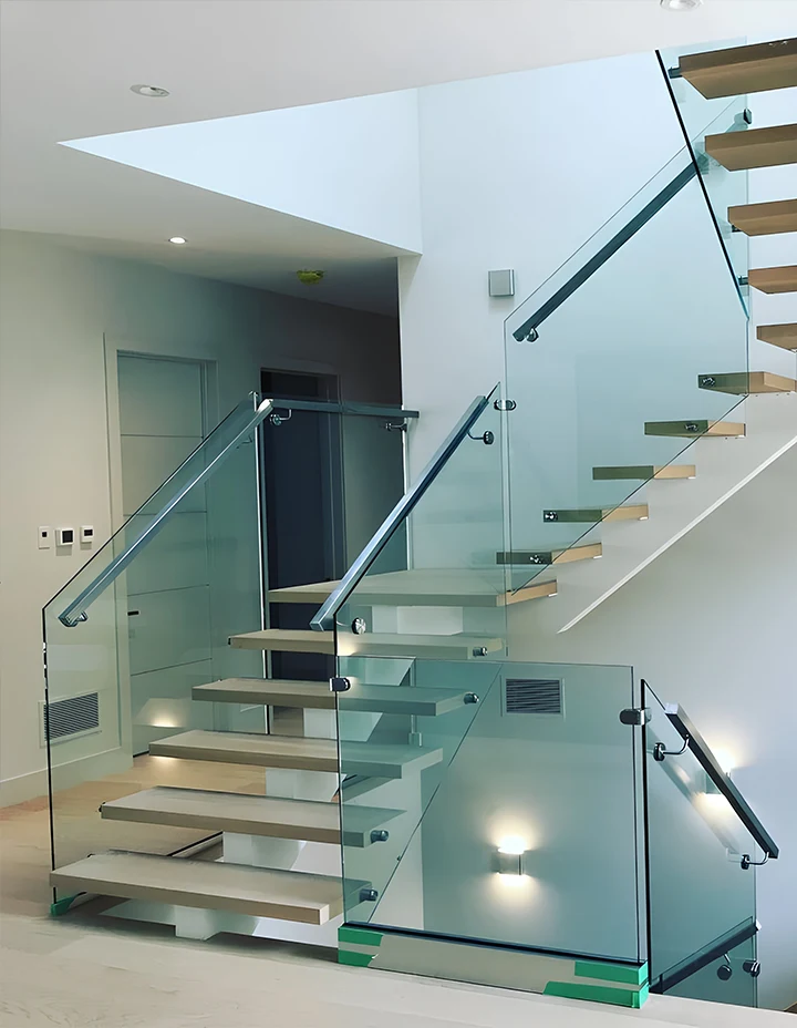 Stunning glass staircase with sleek metal and wood design in contemporary interiors.