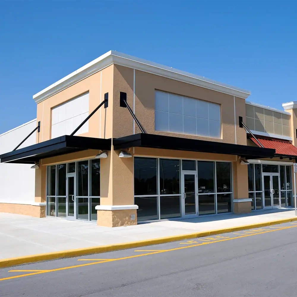 Elegant glass storefront featuring large reflective mirrors and crystal-clear glass panels for commercial spaces.