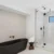 Alt text: Sleek glass shower with modern fixtures and black accents in contemporary bathroom.