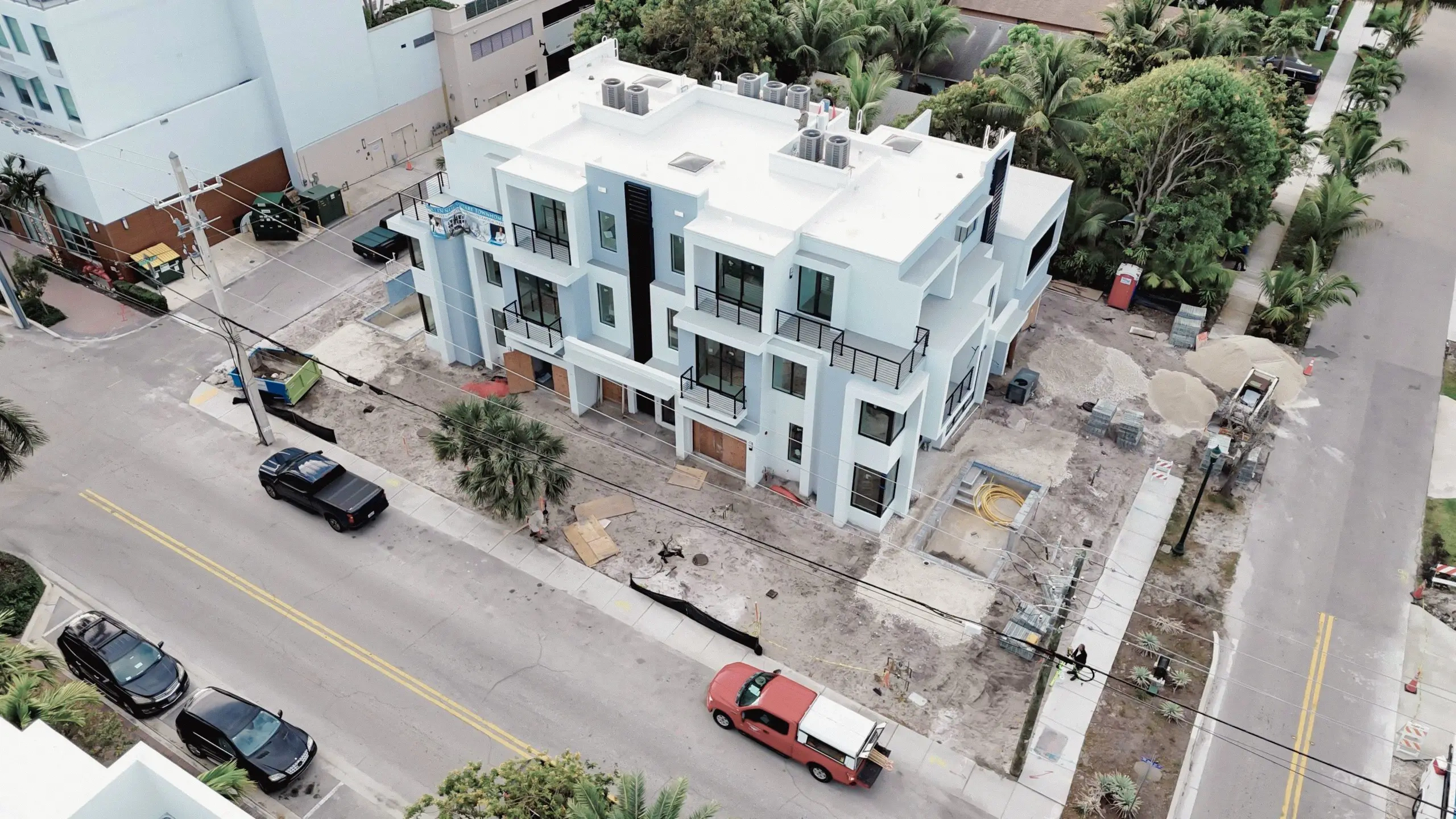 Aerial view of contemporary glass and mirror residential building during construction.
