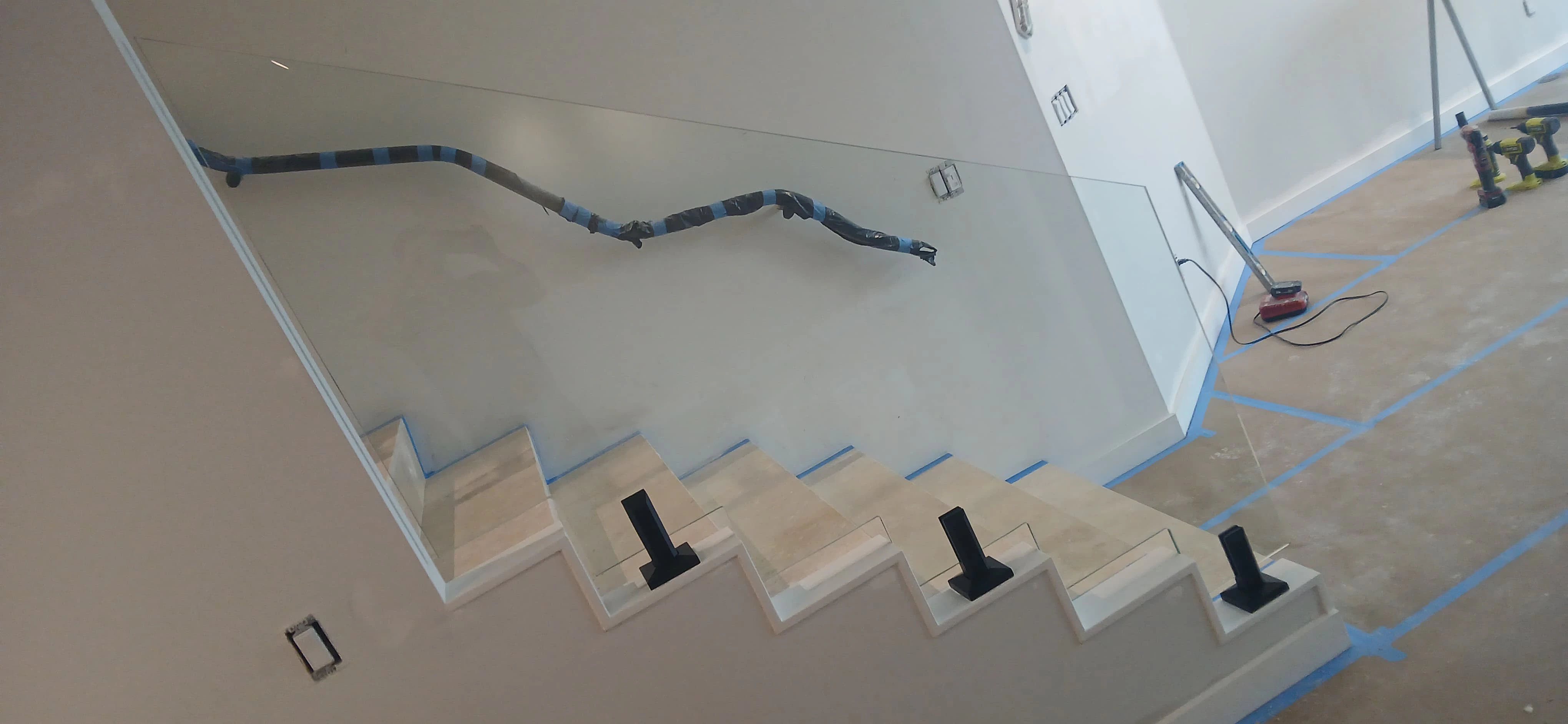 Beautifully crafted glass and mirror installation in a modern staircase setting, enhancing home decor.