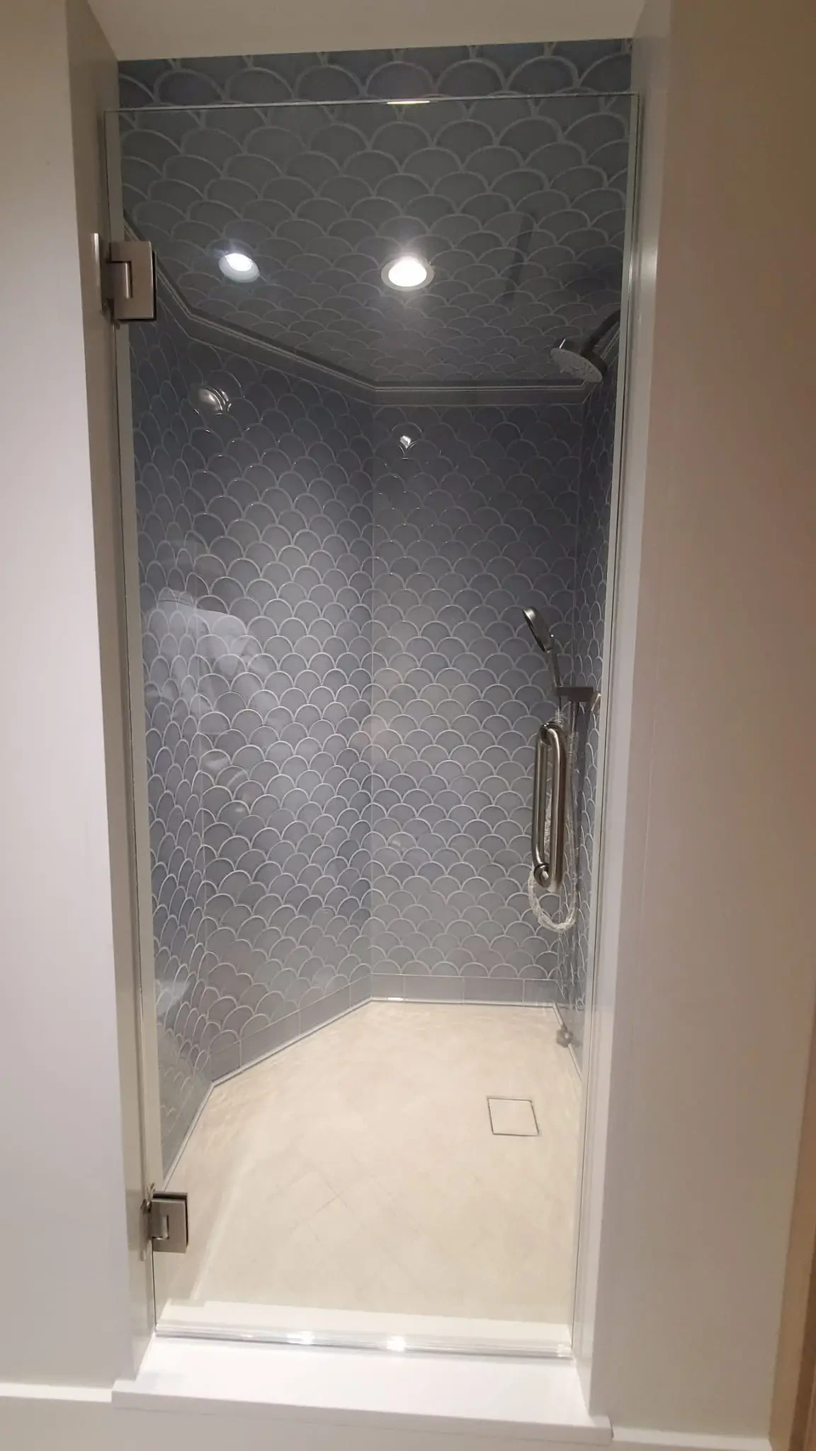 High-quality glass shower enclosure with elegant tile design.