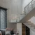 Alt text: Elegant glass railing staircase with metal fittings in contemporary living space, minimalist style.
