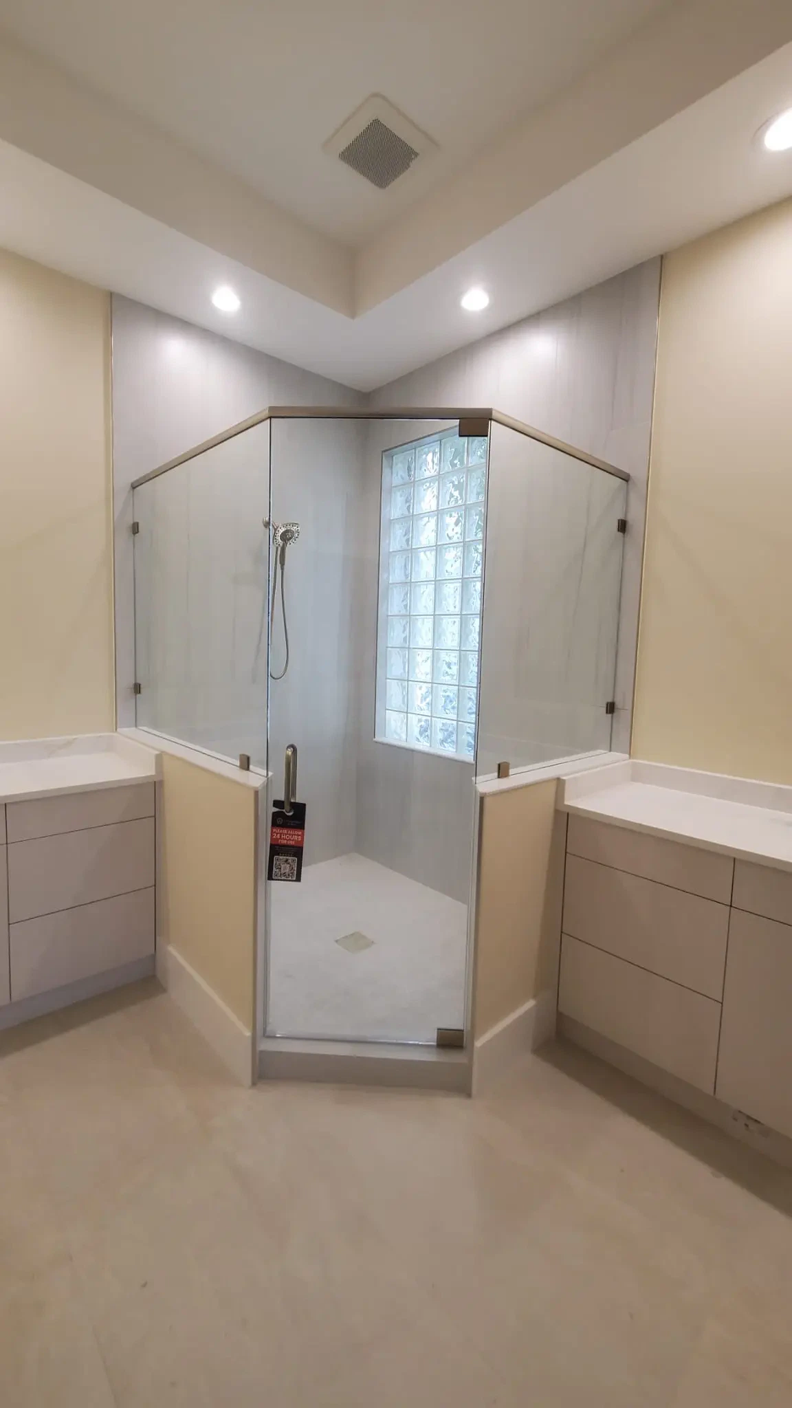 Clean glass shower door with frameless design and modern fixtures.