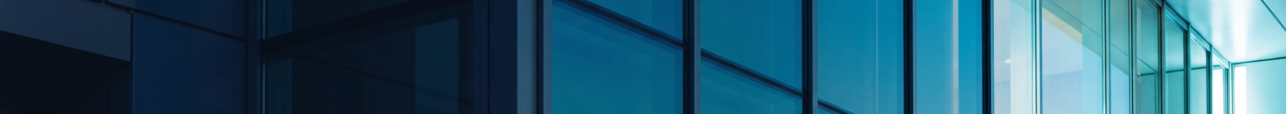 Commercial glass curtain wall at blue hour