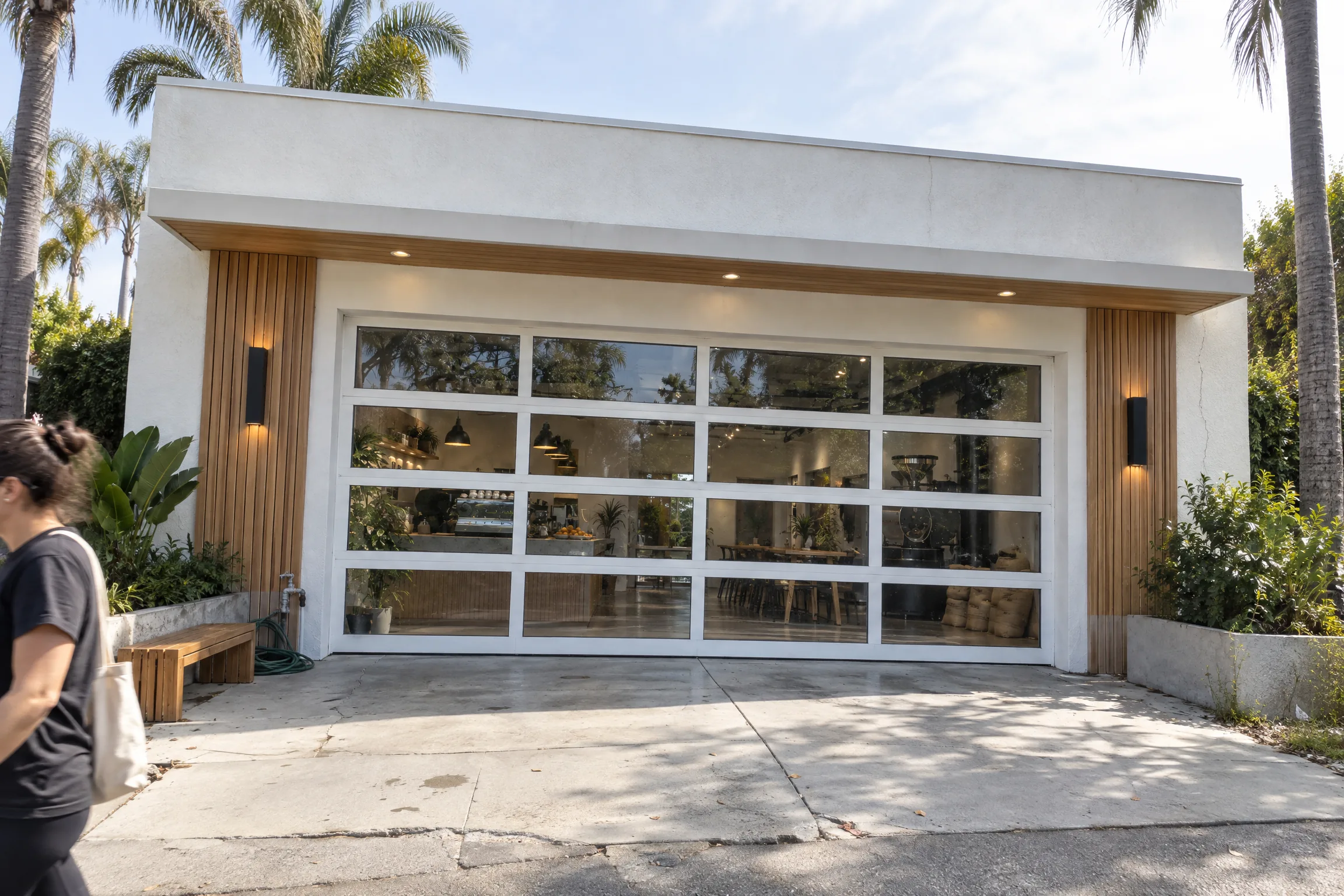 White framed aluminum and glass overhead door on a cafe