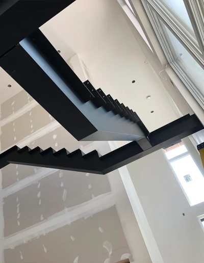 Stainless steel and glass staircase with modern aesthetic, ideal for contemporary interiors.