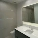 Enhanced bathroom mirror with built-in LED lighting, modern finish, perfect for stylish bathrooms.