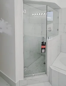High-quality glass shower door with modern hardware, perfect for upscale bathrooms.