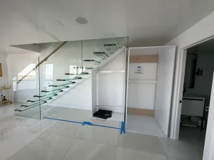 Modern glass staircase with sleek railing and elegant interior finish.