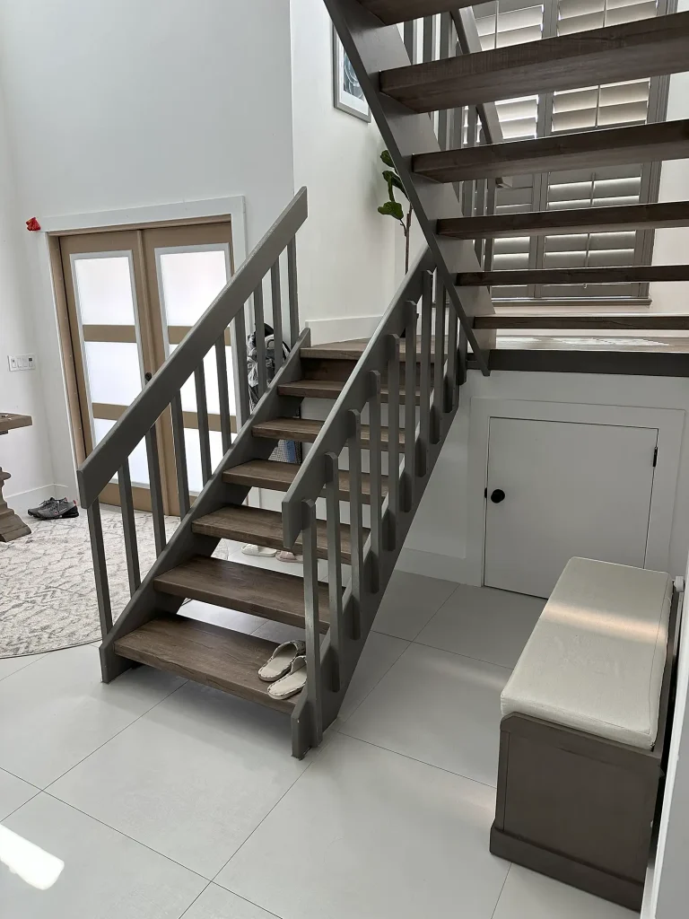 High-quality glass staircase featuring wooden treads and modern metal design.