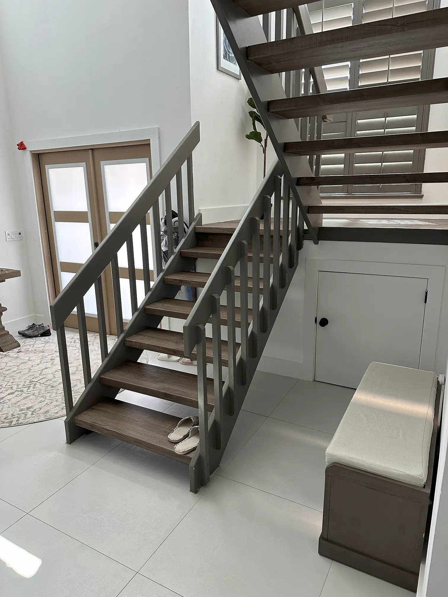 High-quality glass staircase featuring wooden treads and modern metal design.
