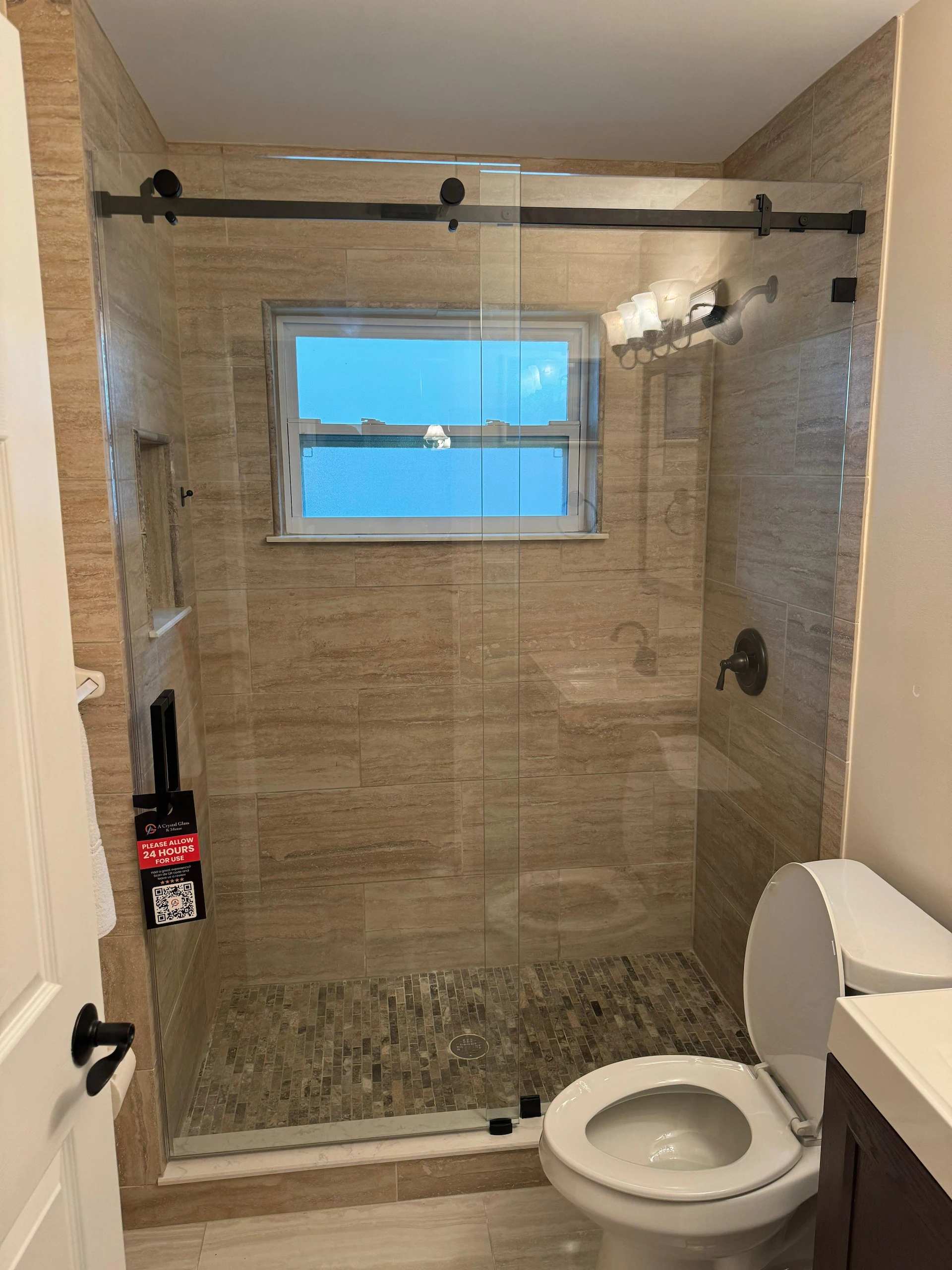 High-quality glass shower door with black hardware, perfect for modern bathrooms.